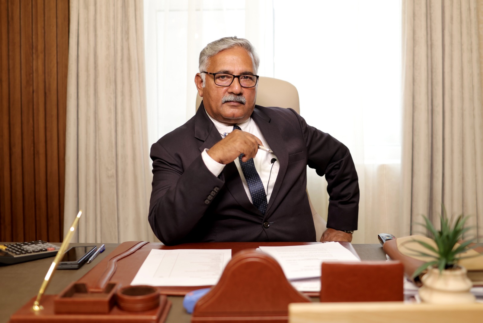 Ibrahim Abdul Rahim, Founder and Group Chairman of Al Thail Group, seated at his desk