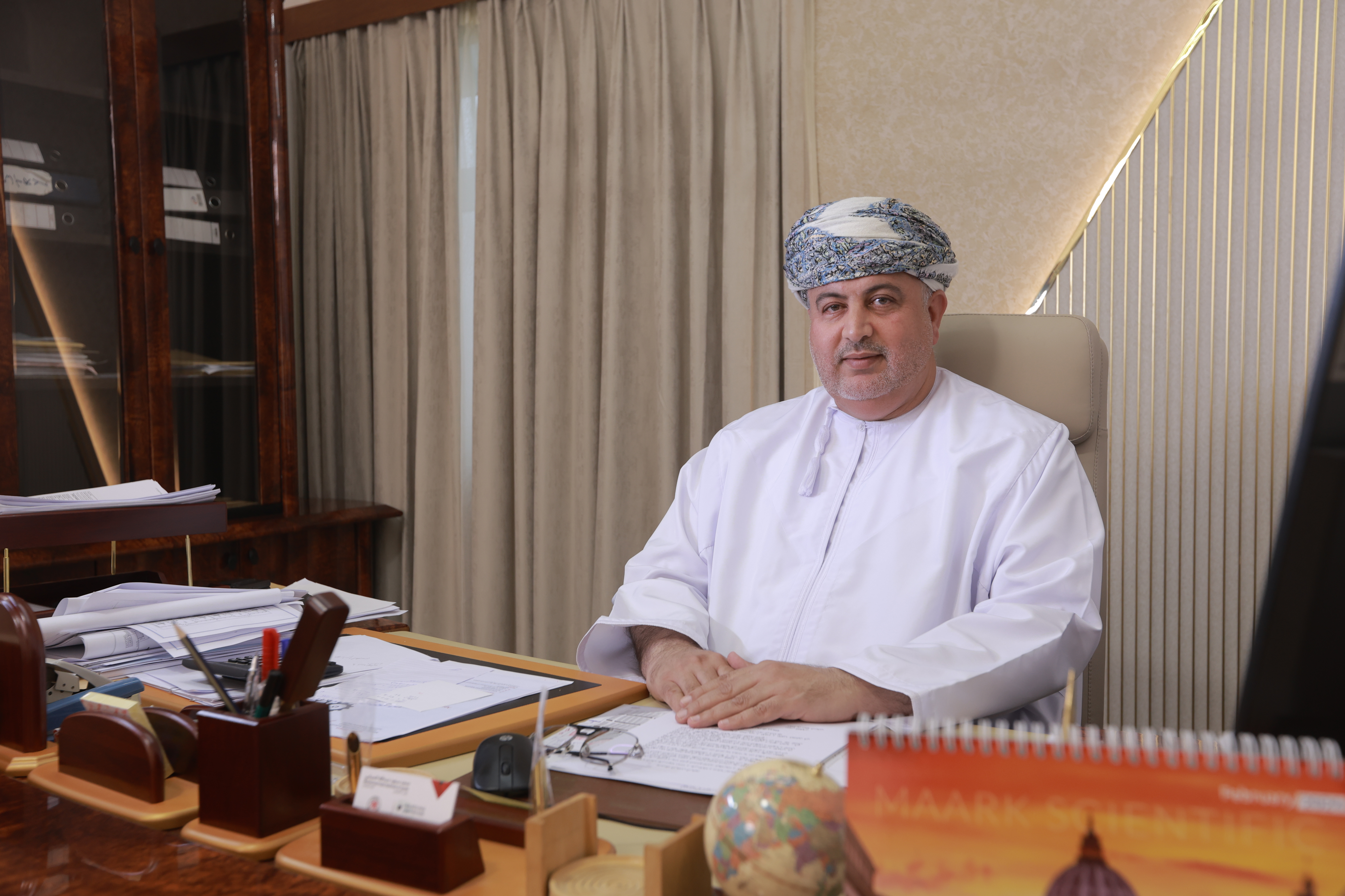 Mohammed Said Abdullah Al Siyabi, Chairman of Al Thail Group, seated at his desk